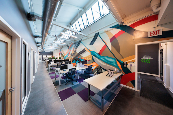 Flex desk corridor with mural at Platform Coworking
